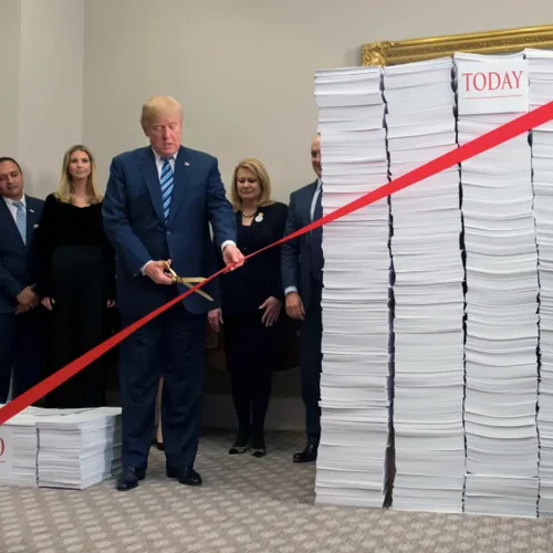 Trump uses gold scissors to cut a red tape